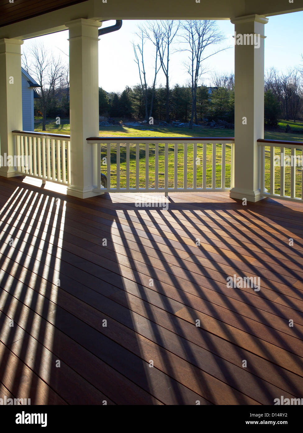 Porch With Sun Shining Making Shadows On Deck Stock Photo