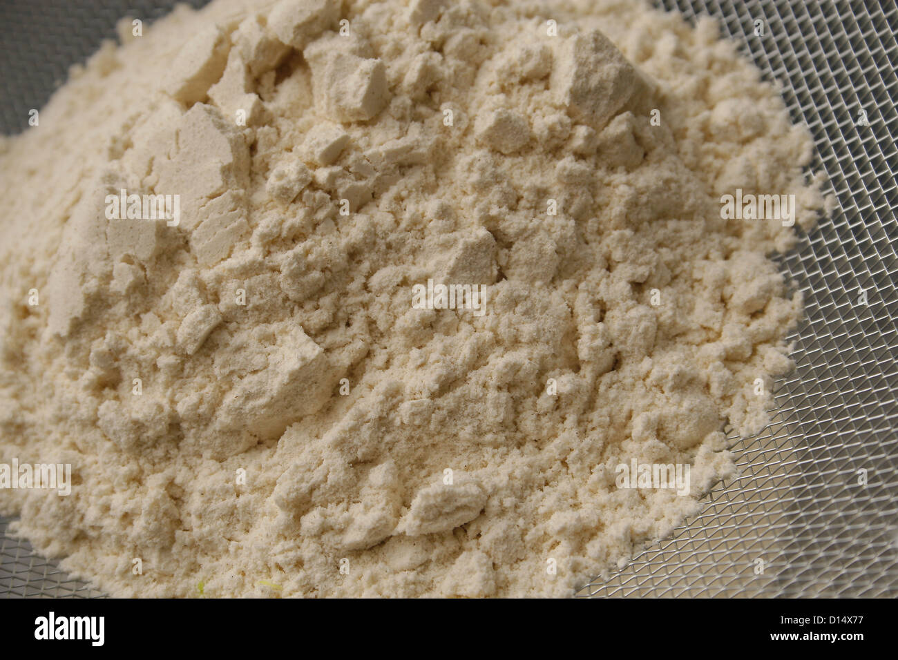 plain flour being sifted by a sieve into a mixing bowl Stock Photo Alamy