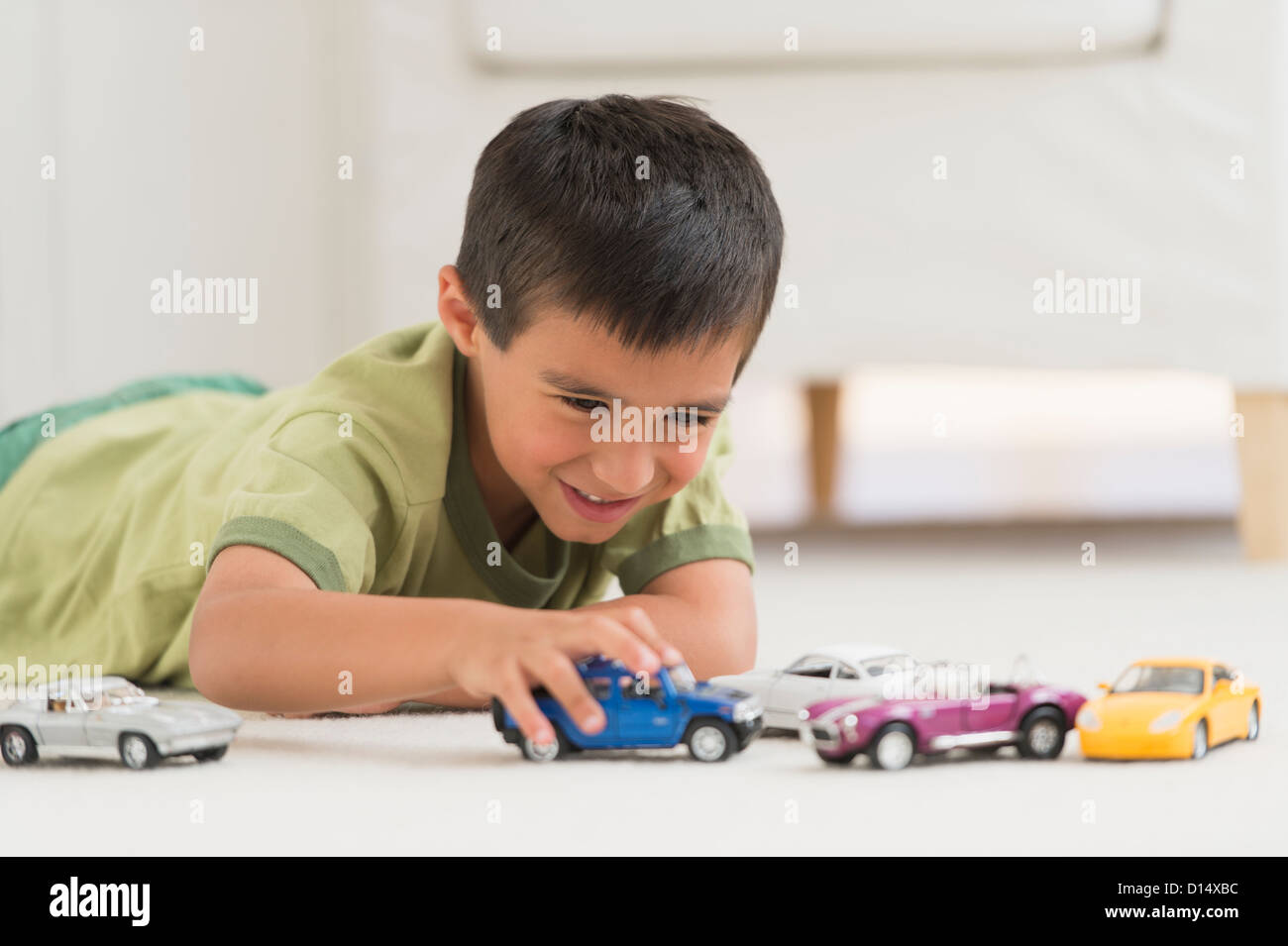 USA, New Jersey, Jersey City, Portrait of boy (6-7) playing with toy cars Stock Photo