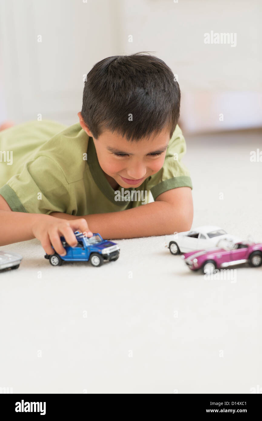 USA, New Jersey, Jersey City, Portrait of boy (6-7) playing with toy cars Stock Photo