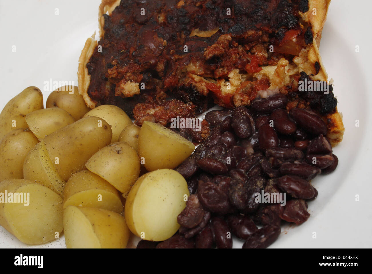 homemade crusty vegetarian mexican bean bake served with new potatoes