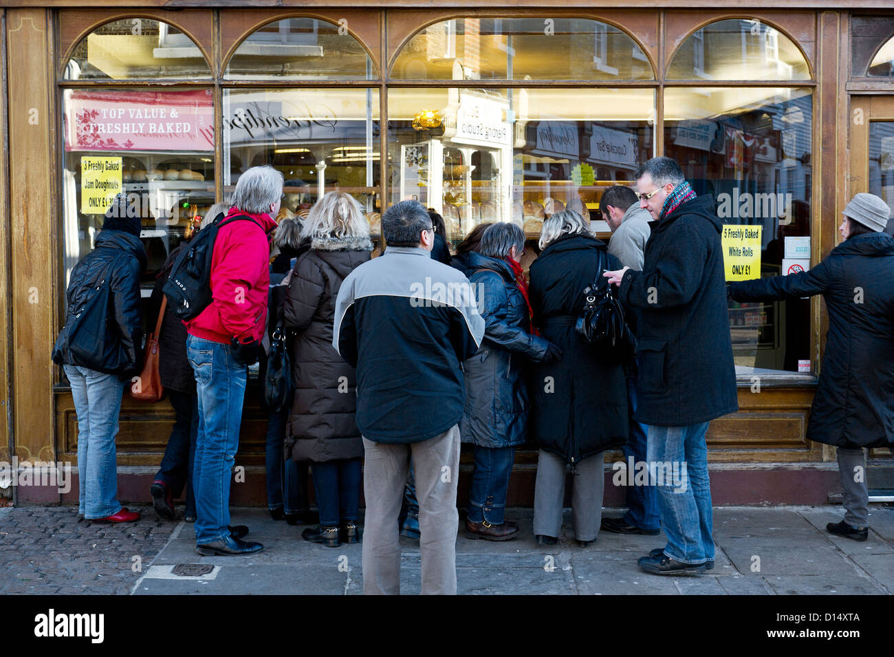 People looking into a shop window. Stock Photo