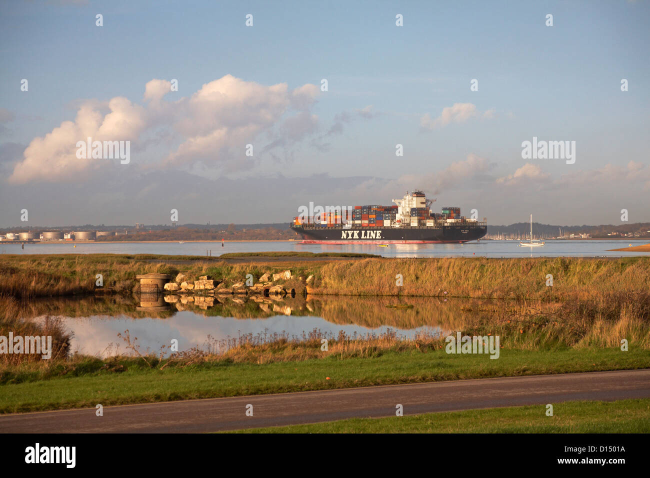 Container ship NYK Line Vega sailing into Southampton at Calshot Hampshire UK in November - shipping containers freight cargo Stock Photo