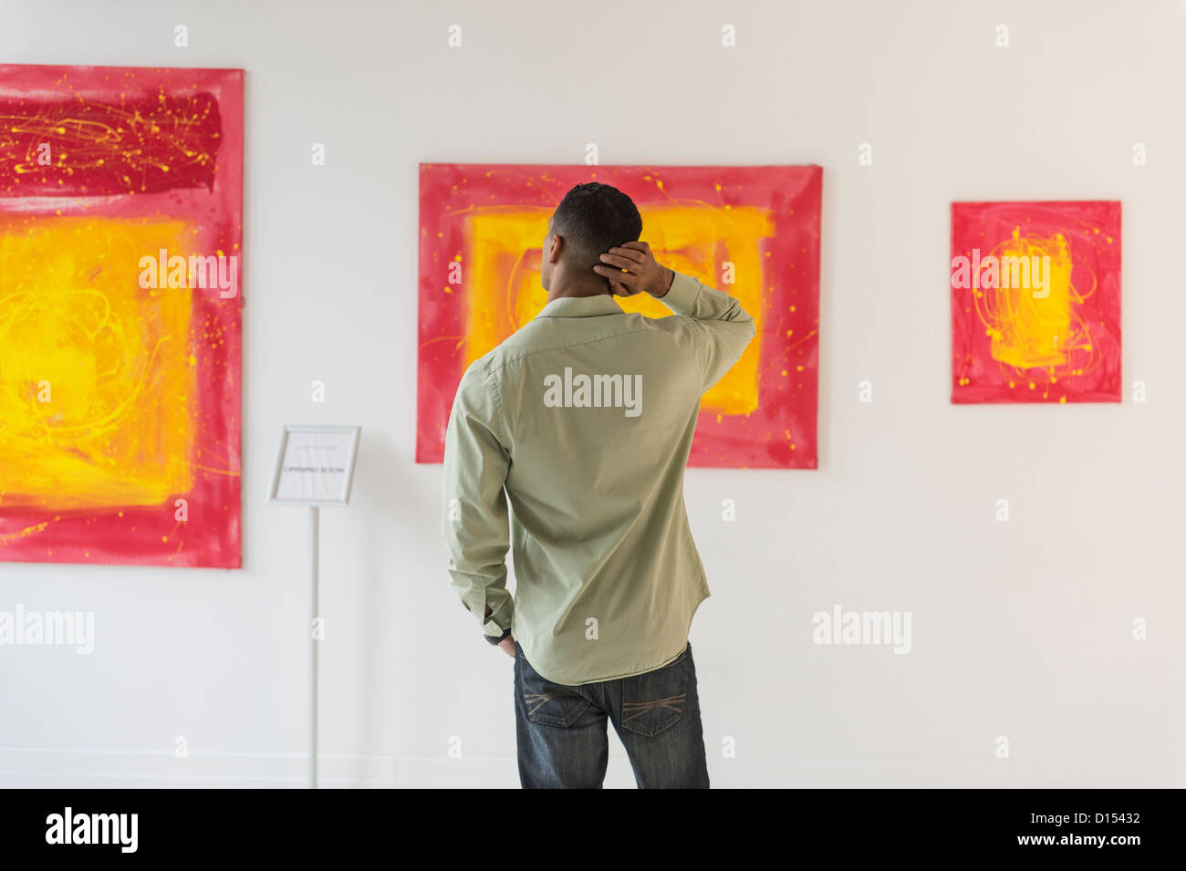 USA, New Jersey, Jersey City, Man watching paintings in modern art gallery Stock Photo
