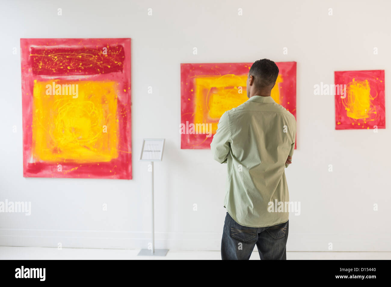 USA, New Jersey, Jersey City, Man watching paintings in modern art gallery Stock Photo