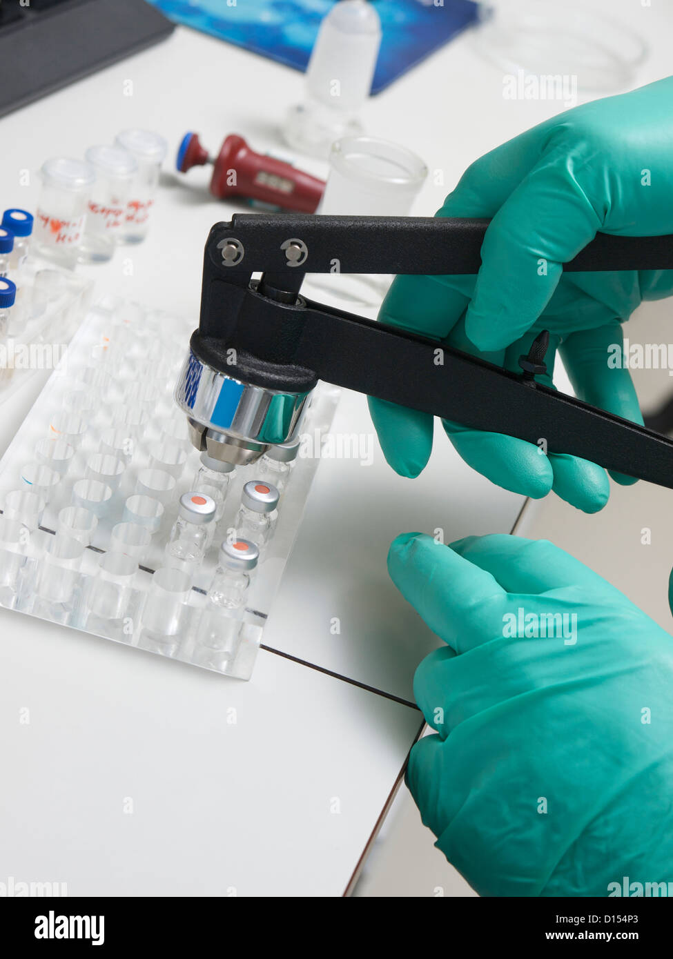 Capping serum flasks bottles in a laboratory, Tilburg, the Netherlands Stock Photo