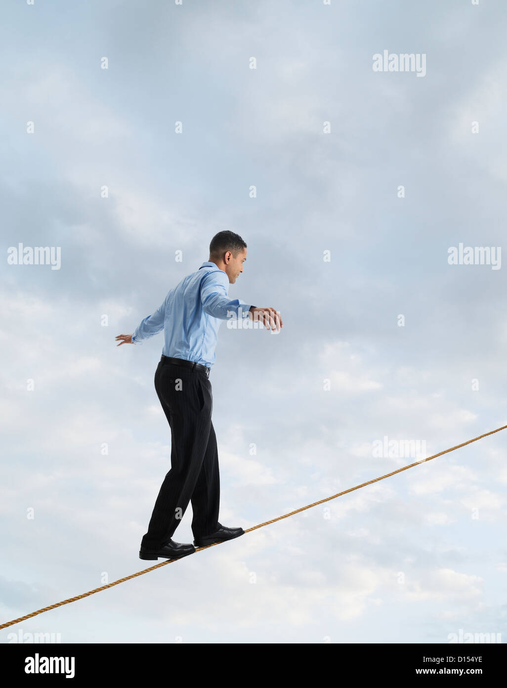 Man balancing on tightrope, studio shot Stock Photo - Alamy