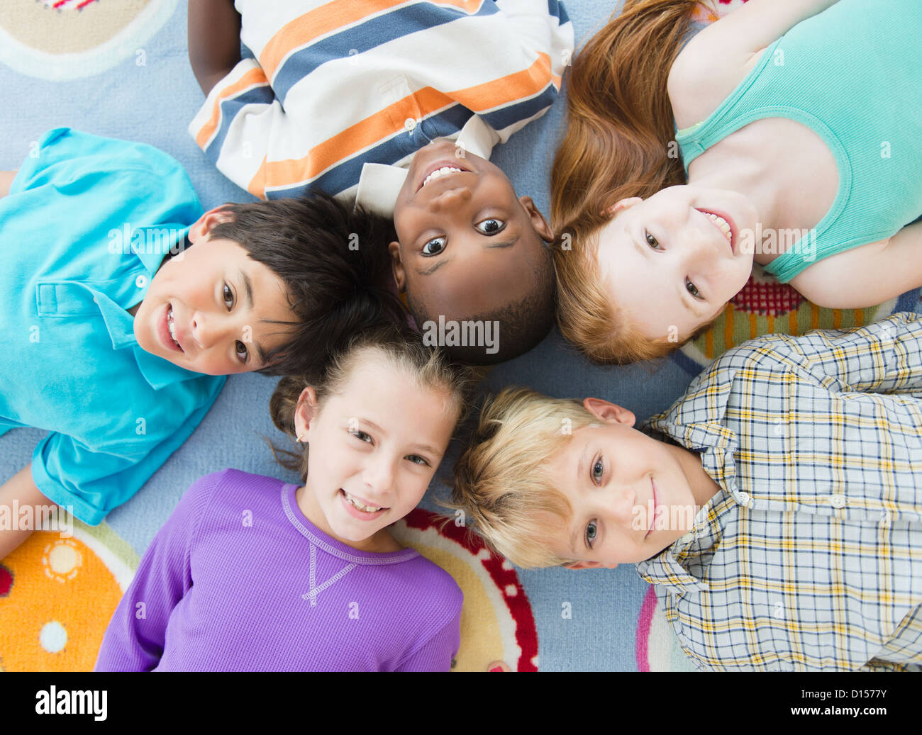 Five children lying on floor hi-res stock photography and images - Alamy