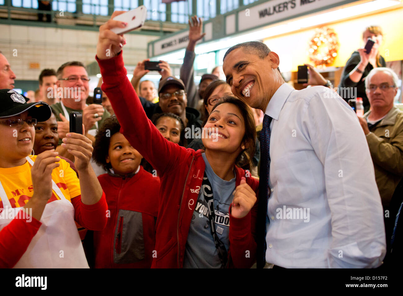 US President Barack Obama has his picture taken with a patron while campaigning at the West Side Market October 5, 2012 in Cleveland, Ohio. Stock Photo