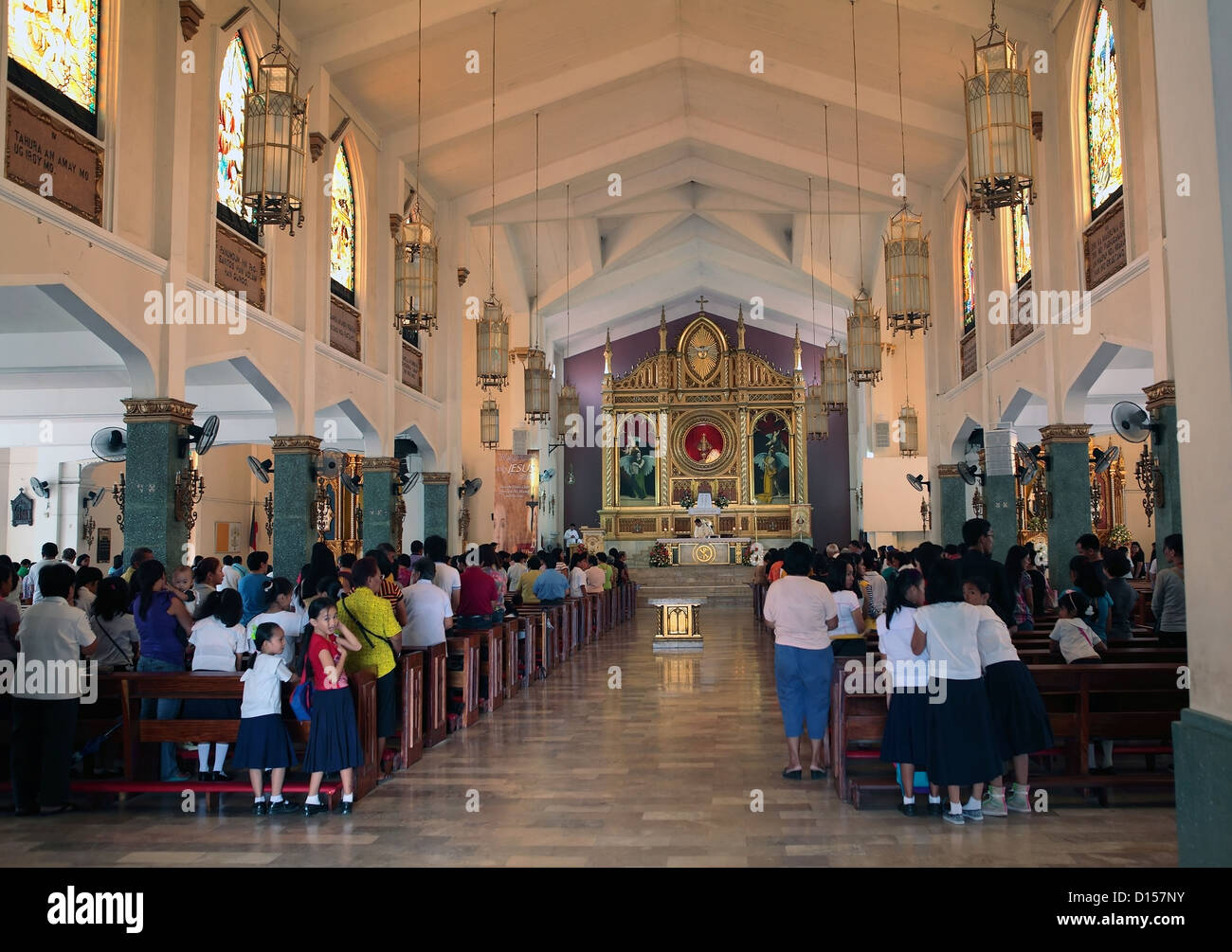 People praying in the Catholic church in Tacloban, Leyte. Stock Photo