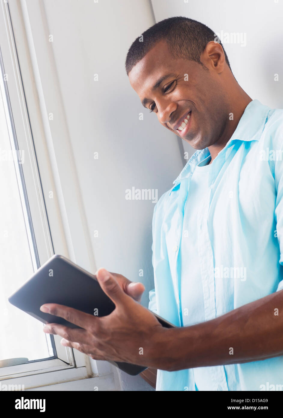 Young man tablet happy hi-res stock photography and images - Alamy