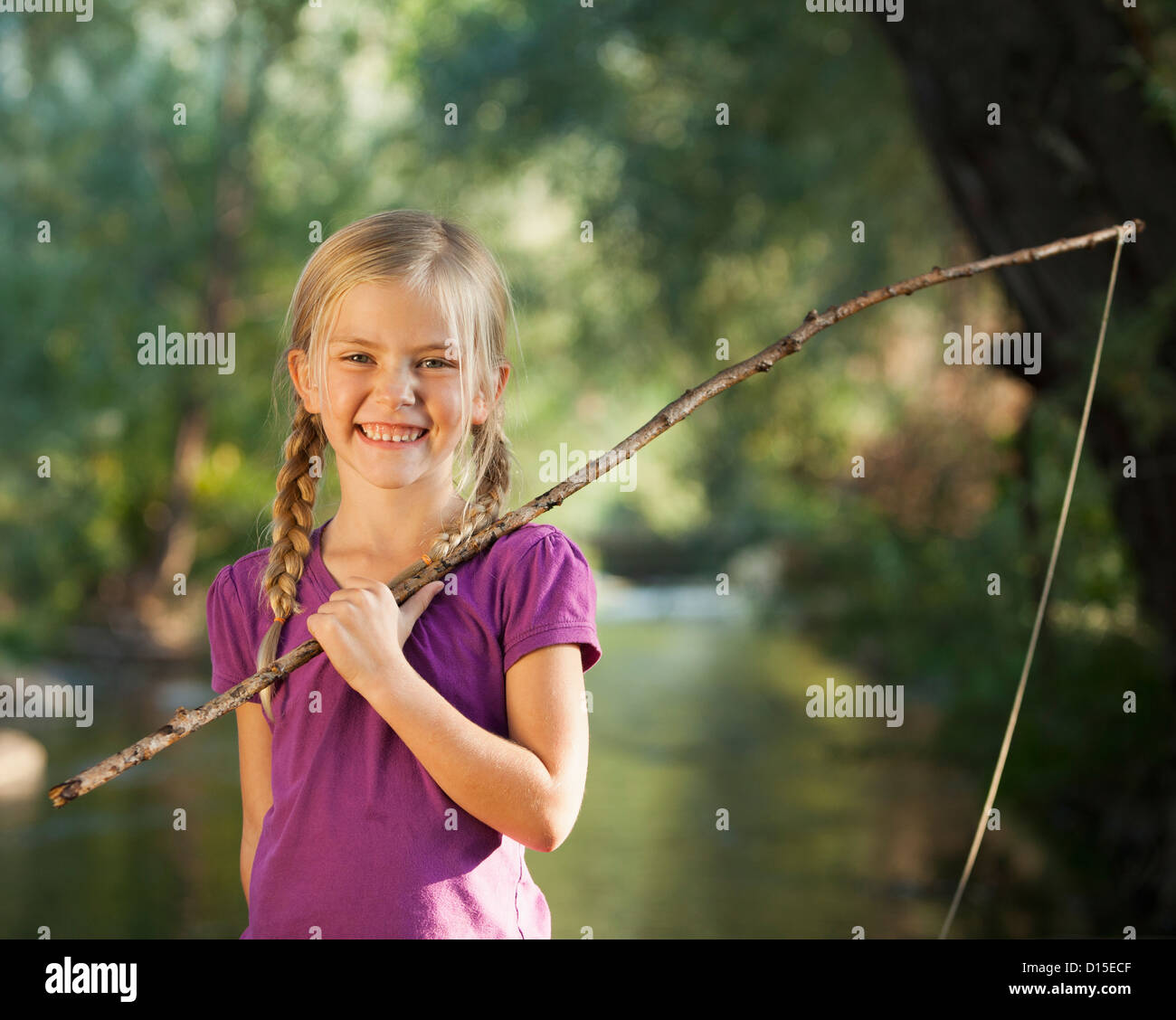 USA, Utah, Lehi, Little girl (4-5) holding wooden stick fishing
