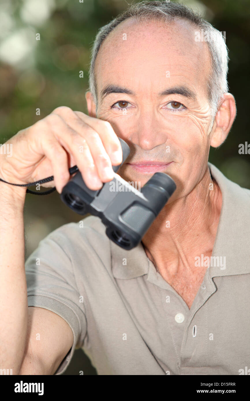 binoculars in hand Stock Photo