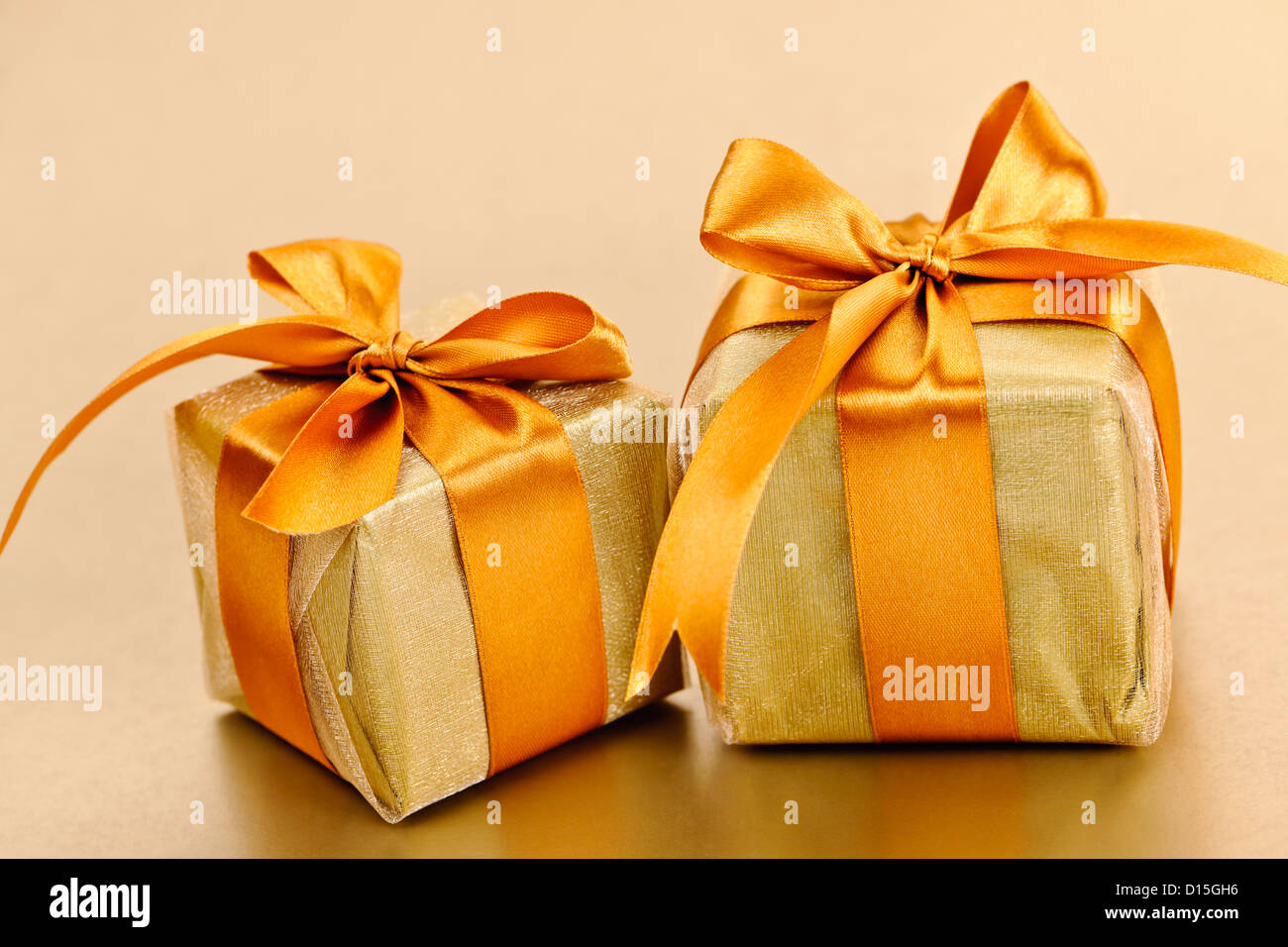 Two gift boxes in gold wrapping paper with ribbon and bow Stock ...