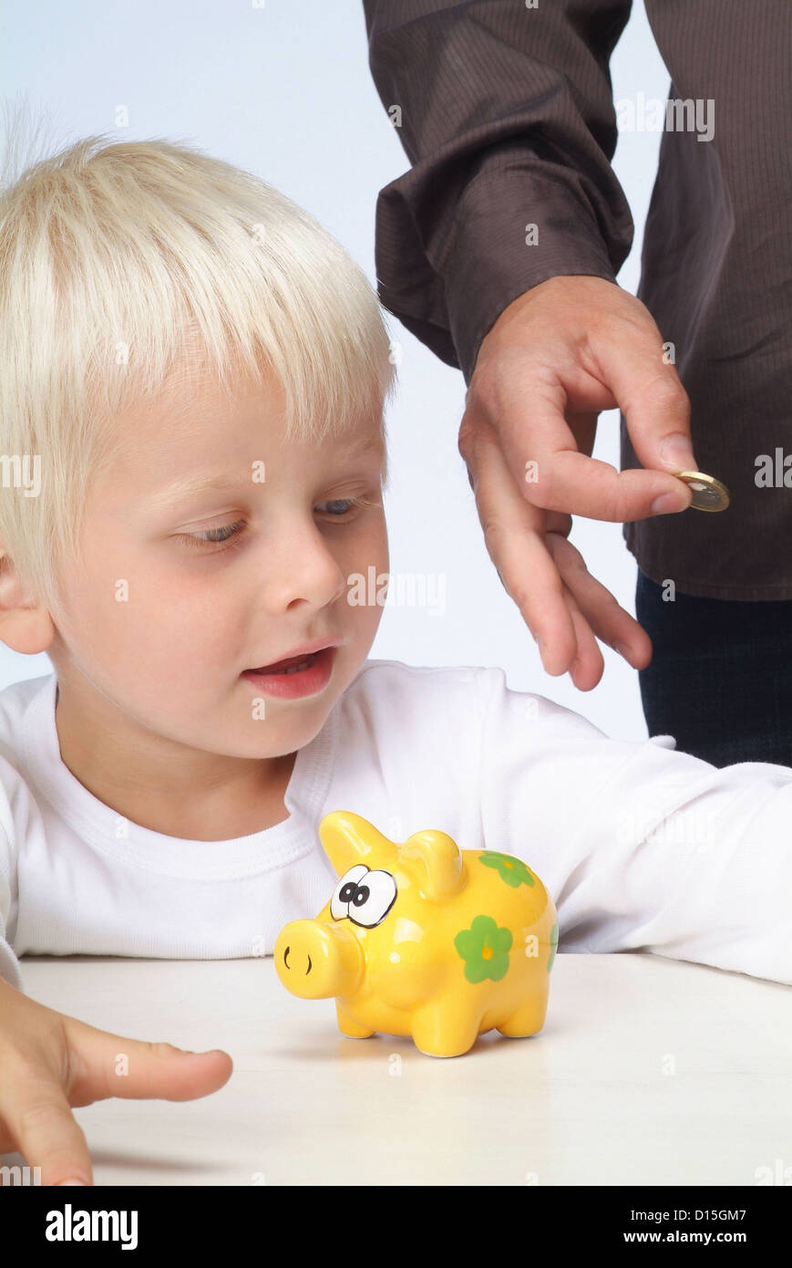 Hamburg, Germany, a boy gets money for his piggy bank Stock Photo