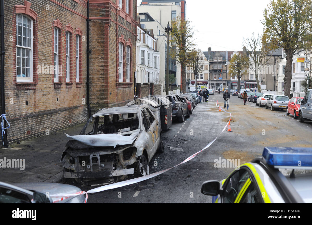 A line of burnt out cars in Connaught Road Hove this morning after seven vehicles all parked along the same kerb Stock Photo
