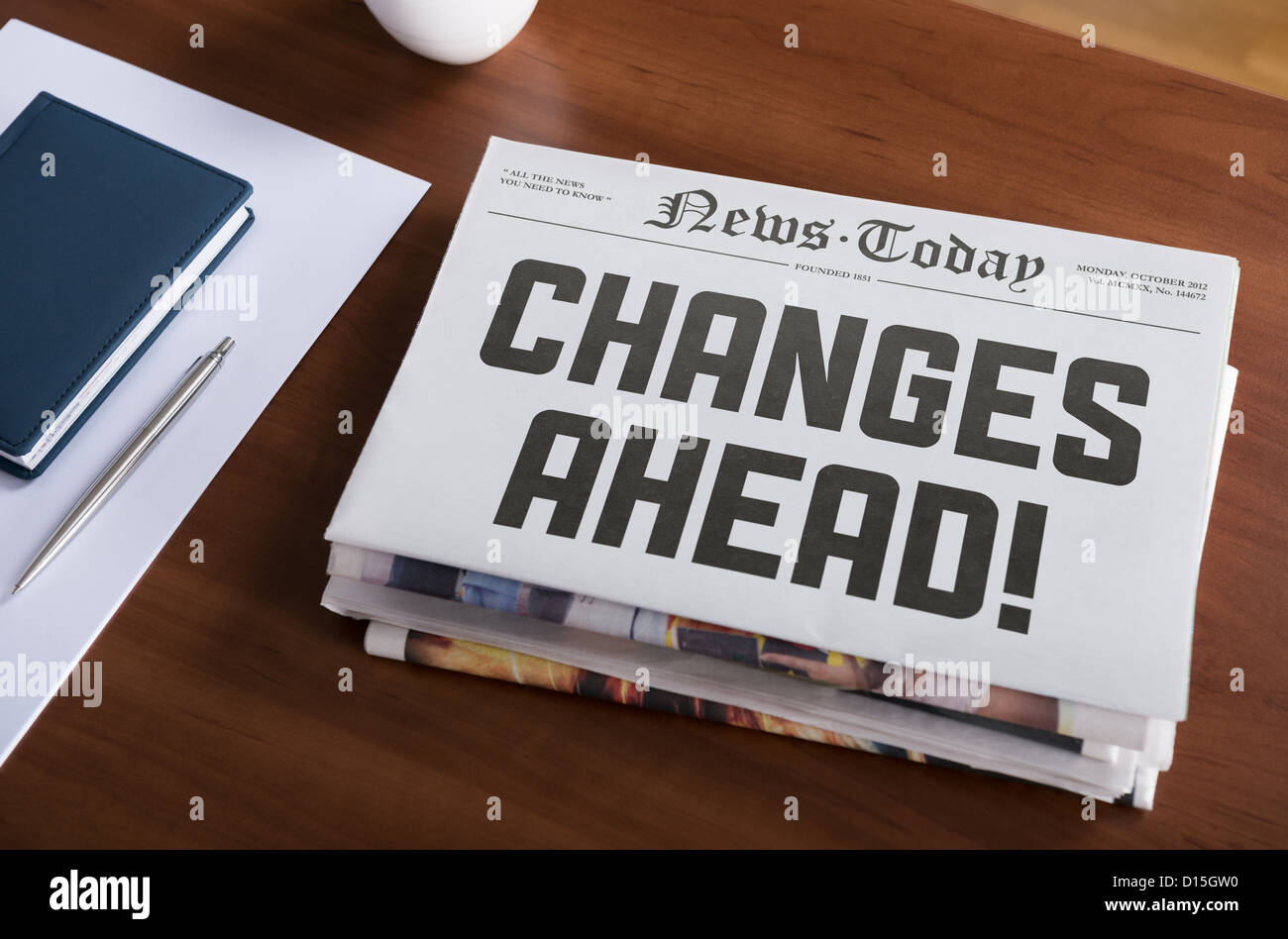 Newspaper with hot topic 'Changes Ahead' lying on office desk. Stock Photo