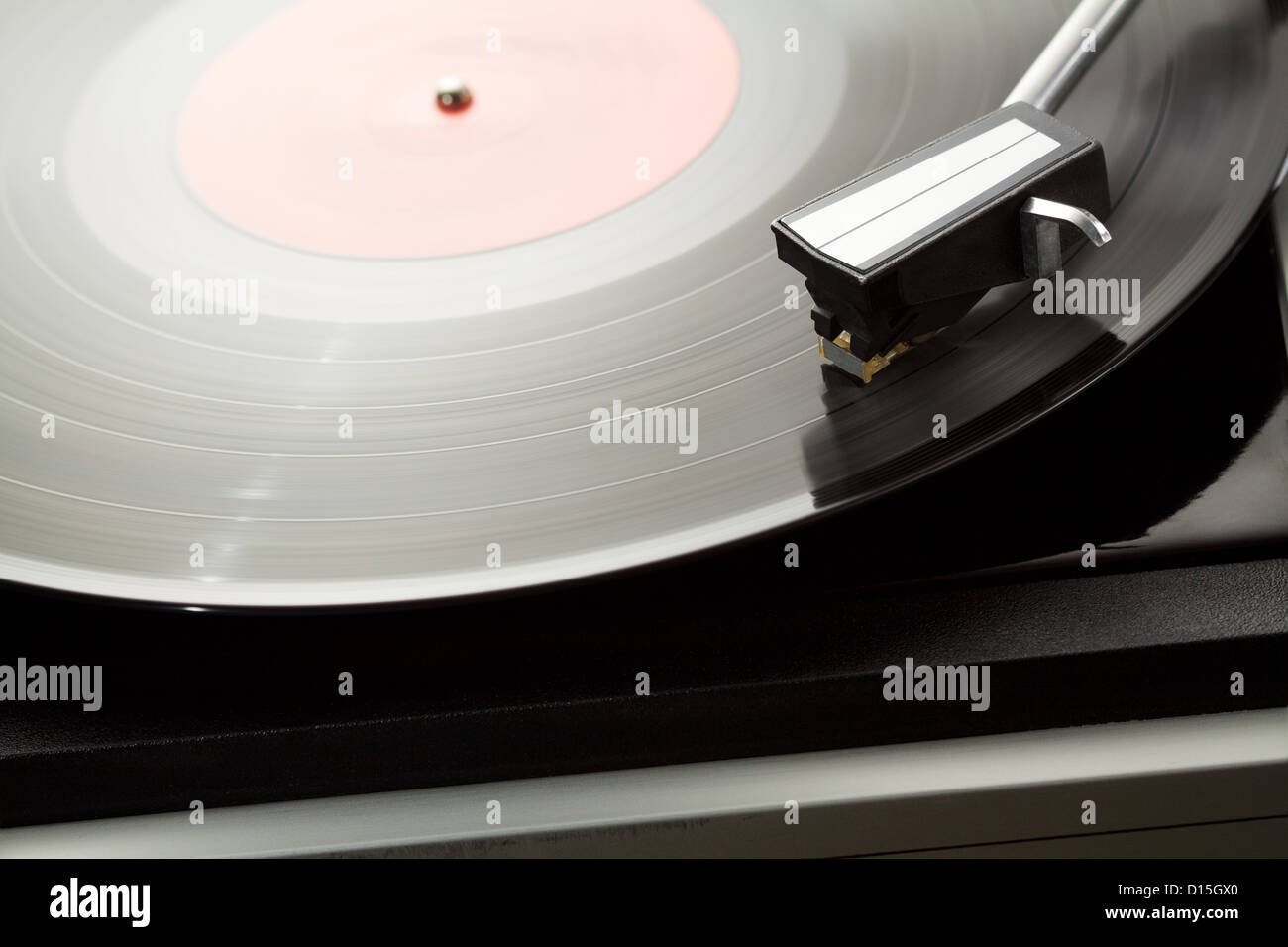 Vintage record player with spinning vinyl. Stock Photo