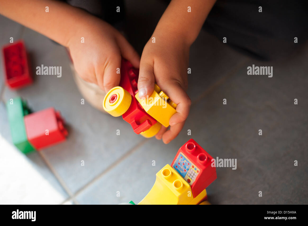 Hand Using Building Blocks hands of a child playing with building blocks Stock Photo - Alamy