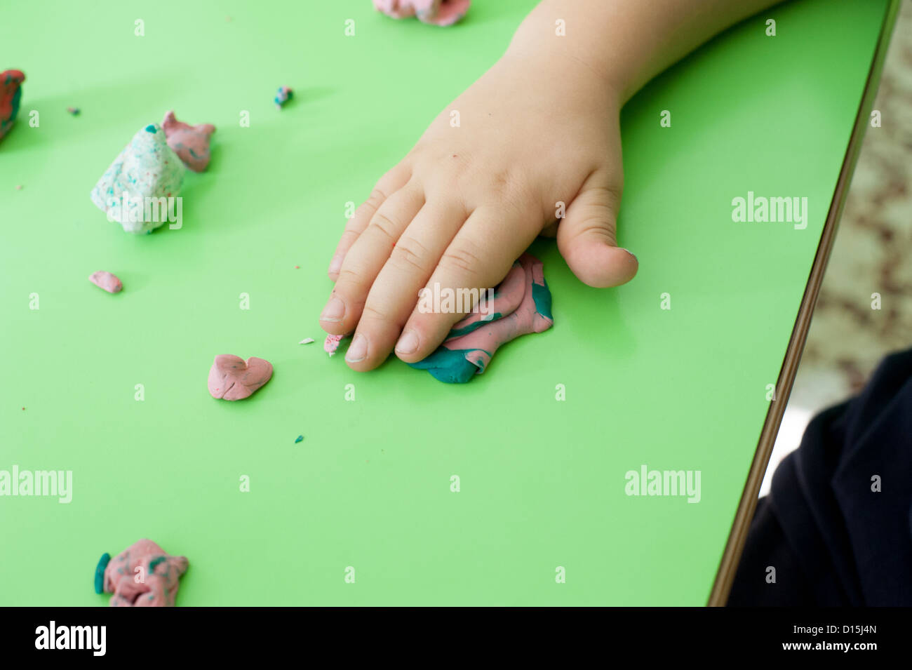 hands of a child playing plasticine Stock Photo