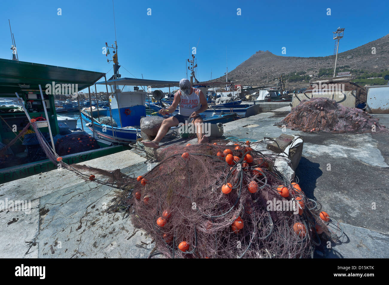 Fisher sewing a fishing net hires stock photography and images Alamy