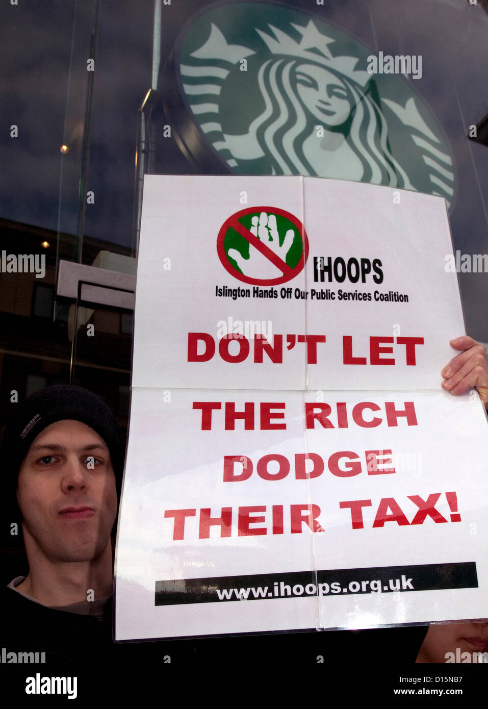 UK Uncut activists protest against Starbucks tax avoidance outside branch in Islington, London Stock Photo