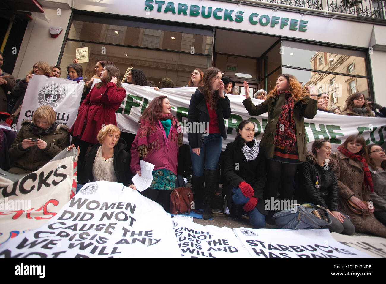 London, UK. 08.12.2012  UK Uncut protesters outside the Vigo Street branch. The protesters transformed Starbucks branches into services women depend on such as refuges and creches, arguing that public services cuts which disproportionately affect women could be prevented with the money gained if the government clamped down on corporate tax avoidance. Stock Photo