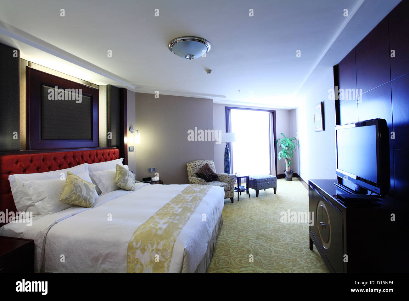 bed in modern living room Stock Photo - Alamy