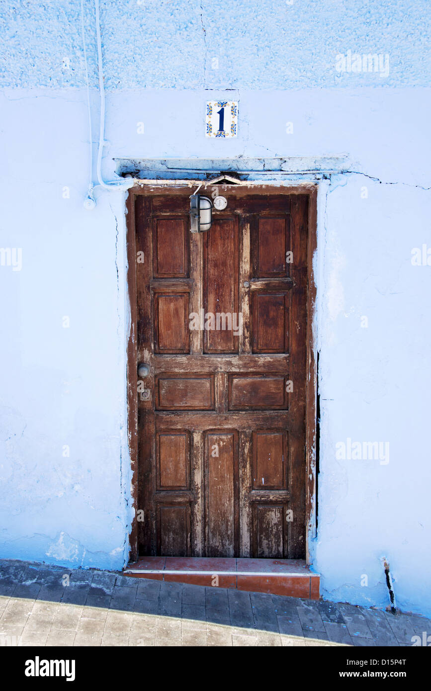 old wooden door with blue painted wall Stock Photo - Alamy