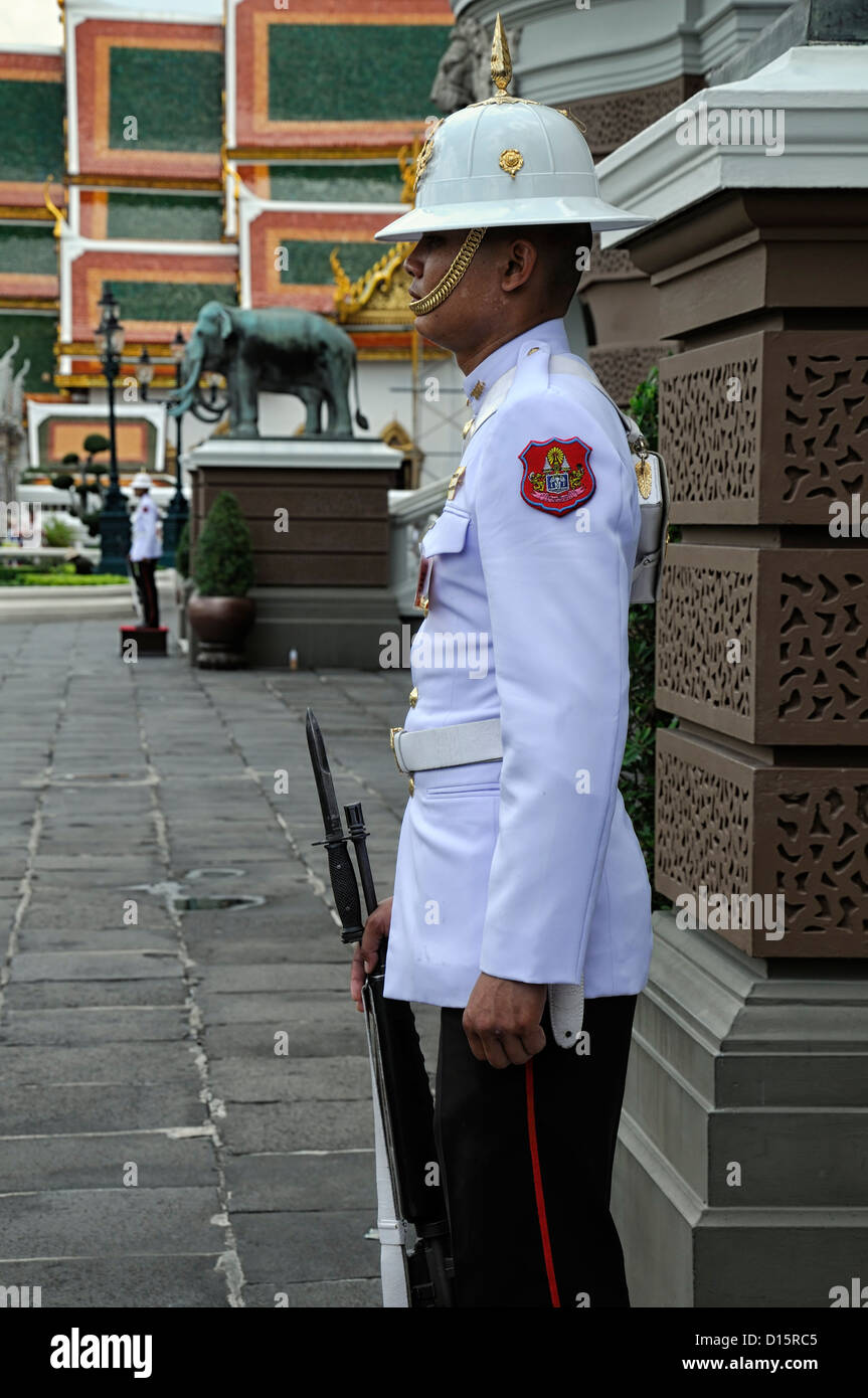 Grand Palace Bangkok Thailand Wat Phra Kaew Temple of the Emerald Buddha ceremonial guard standing white tunic Stock Photo
