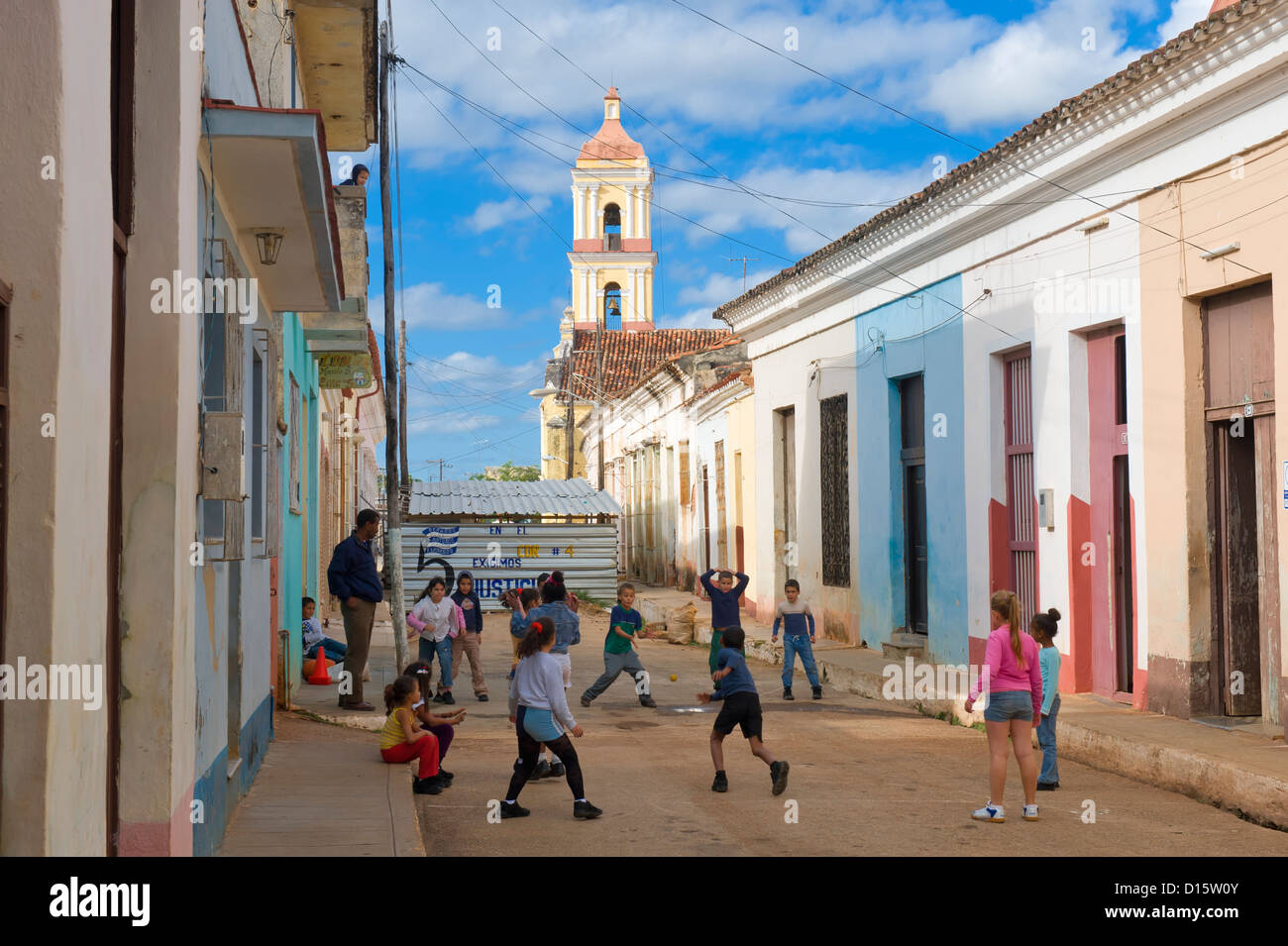 Children playing in front of San Juan Bautista or Parochial Mayor Church, Remedios, Cuba Stock Photo