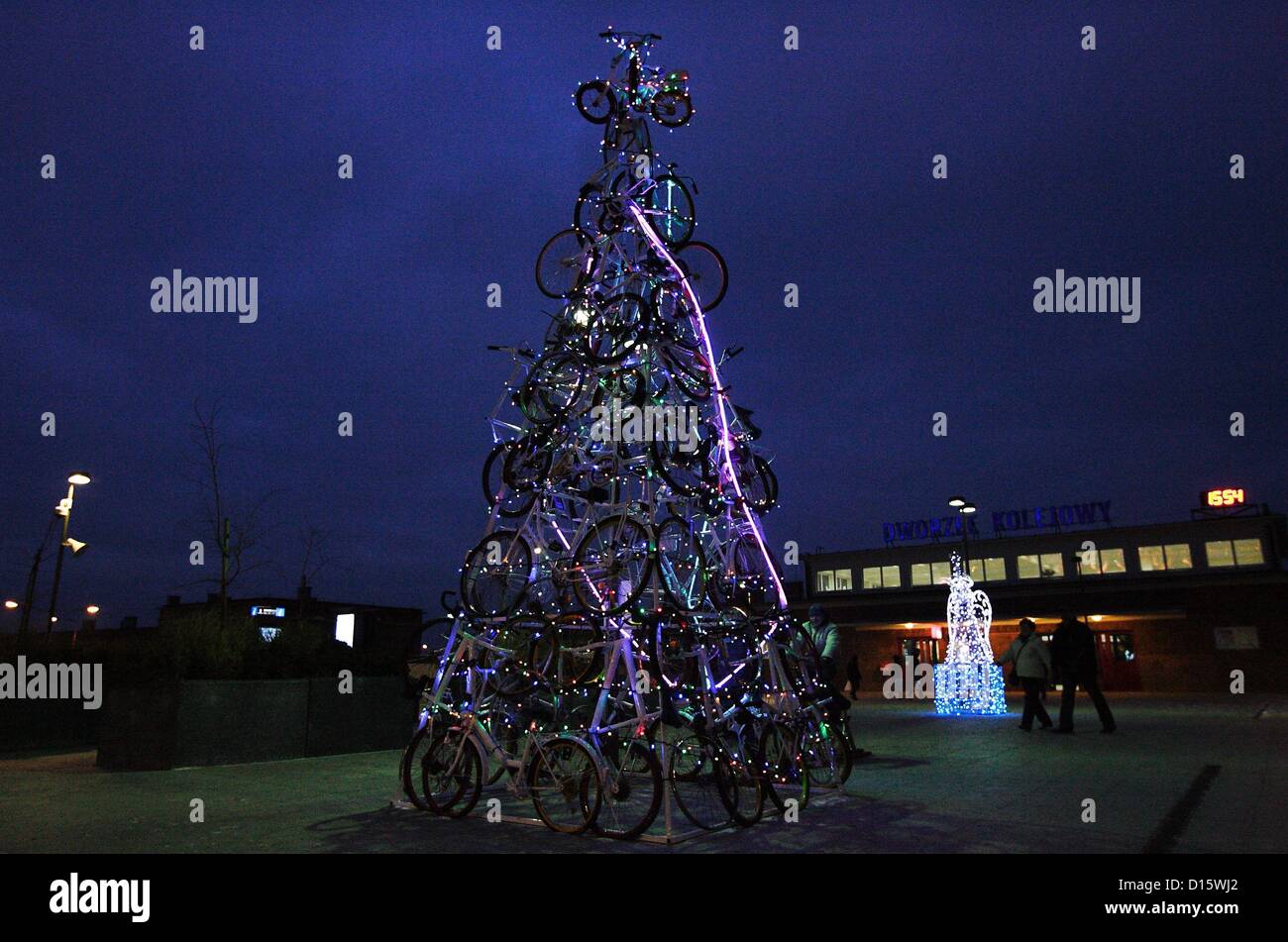 Tczew, Poland 8th, December 2012  Christmas tree made of bicycles on square in front of Tczew railway station entrance. Every passerby can get on the bike and pedaling light Christmas lights on the Christmas tree. Stock Photo