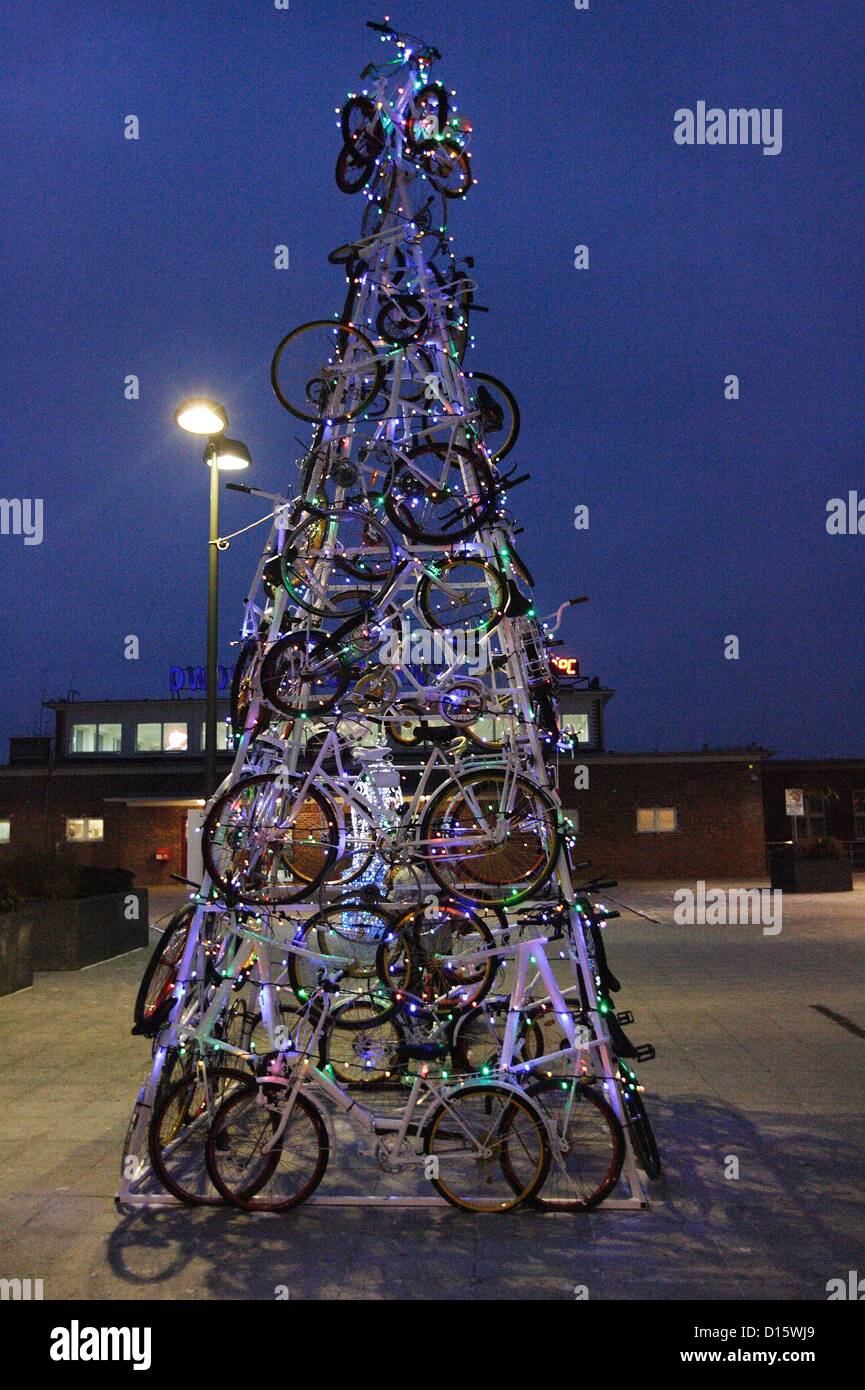 Tczew, Poland 8th, December 2012  Christmas tree made of bicycles on square in front of Tczew railway station entrance. Every passerby can get on the bike and pedaling light Christmas lights on the Christmas tree. Stock Photo