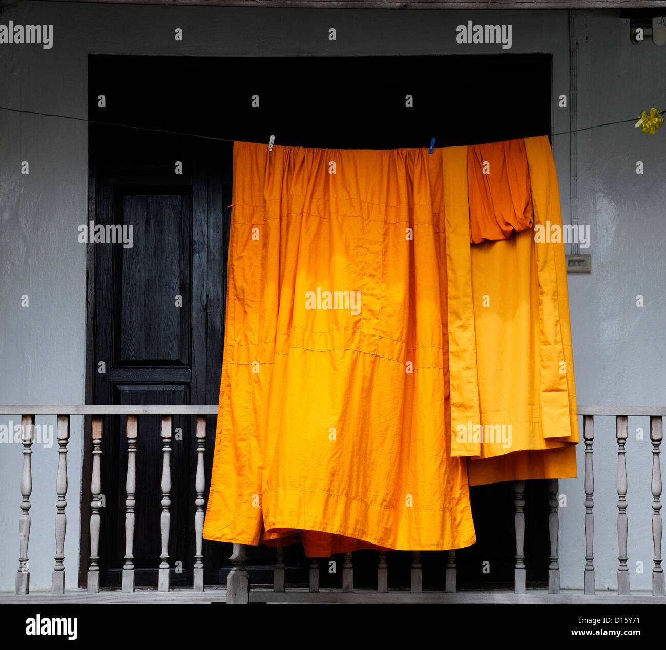 Monks orange robes dry drying washed washing laundry Wat Thepthidaram Temple of the Great Poet Bangkok Thailand buddhist shrine Stock Photo