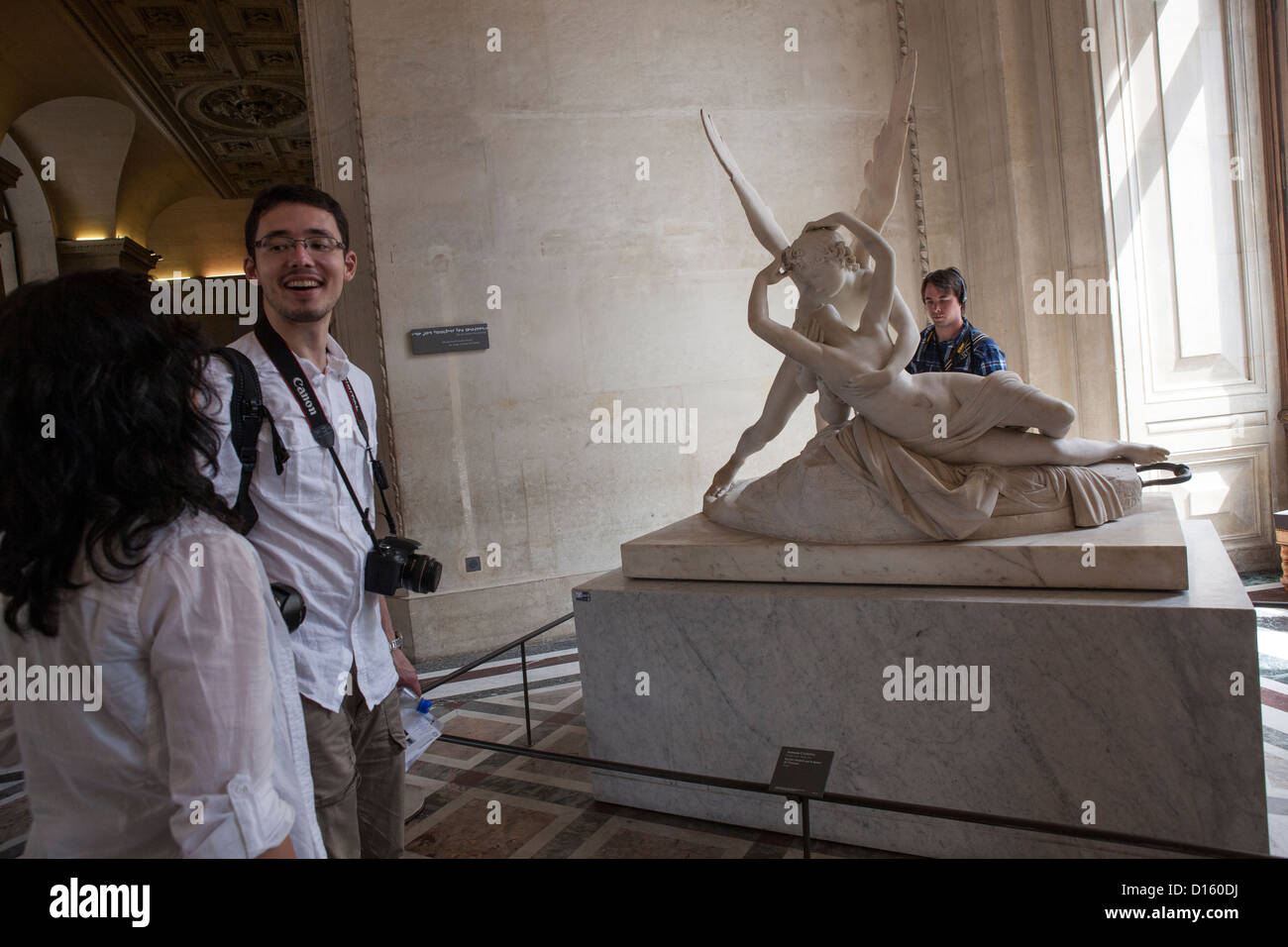 Tourists gaze upon Psyche Revived by Cupid's Kiss - Musée du Louvre, Paris Stock Photo