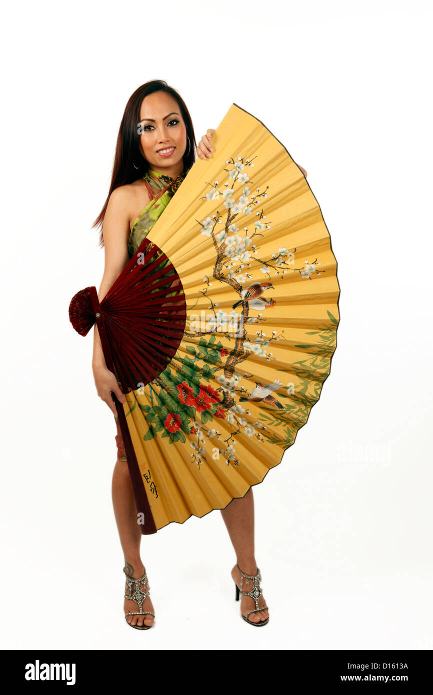 Young beautiful Asian woman holding a silk fan Stock Photo