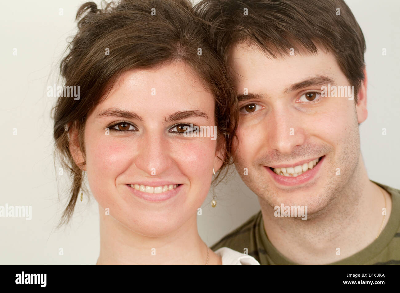 Portrait of young couple smiling and looking at the camera. Close view. Stock Photo