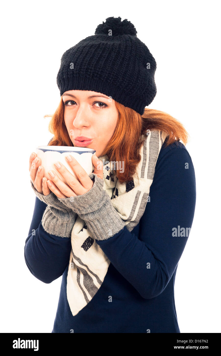 Portrait of young happy woman in winter clothes holding mug with hot drink, isolated on white background. Stock Photo