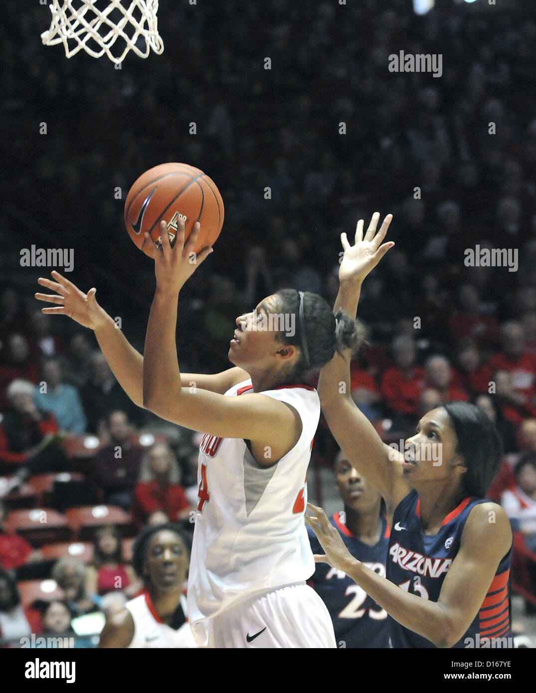 Dec. 8, 2012 - Albuquerque, NM, U.S. - UNM's #34 Whitney Johnson puts up the shot as  Arizona's #13 Cheshi Poston trying to block her in their game Saturday afternoon in the Pit. Saturday, Dec.08, 2012. (Credit Image: © Jim Thompson/Albuquerque Journal/ZUMAPRESS.com) Stock Photo