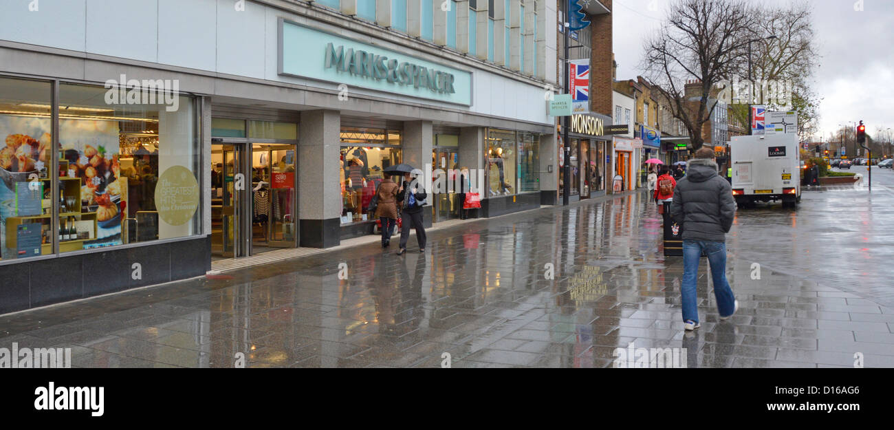 high street shops on wet rainy winter day Stock Photo