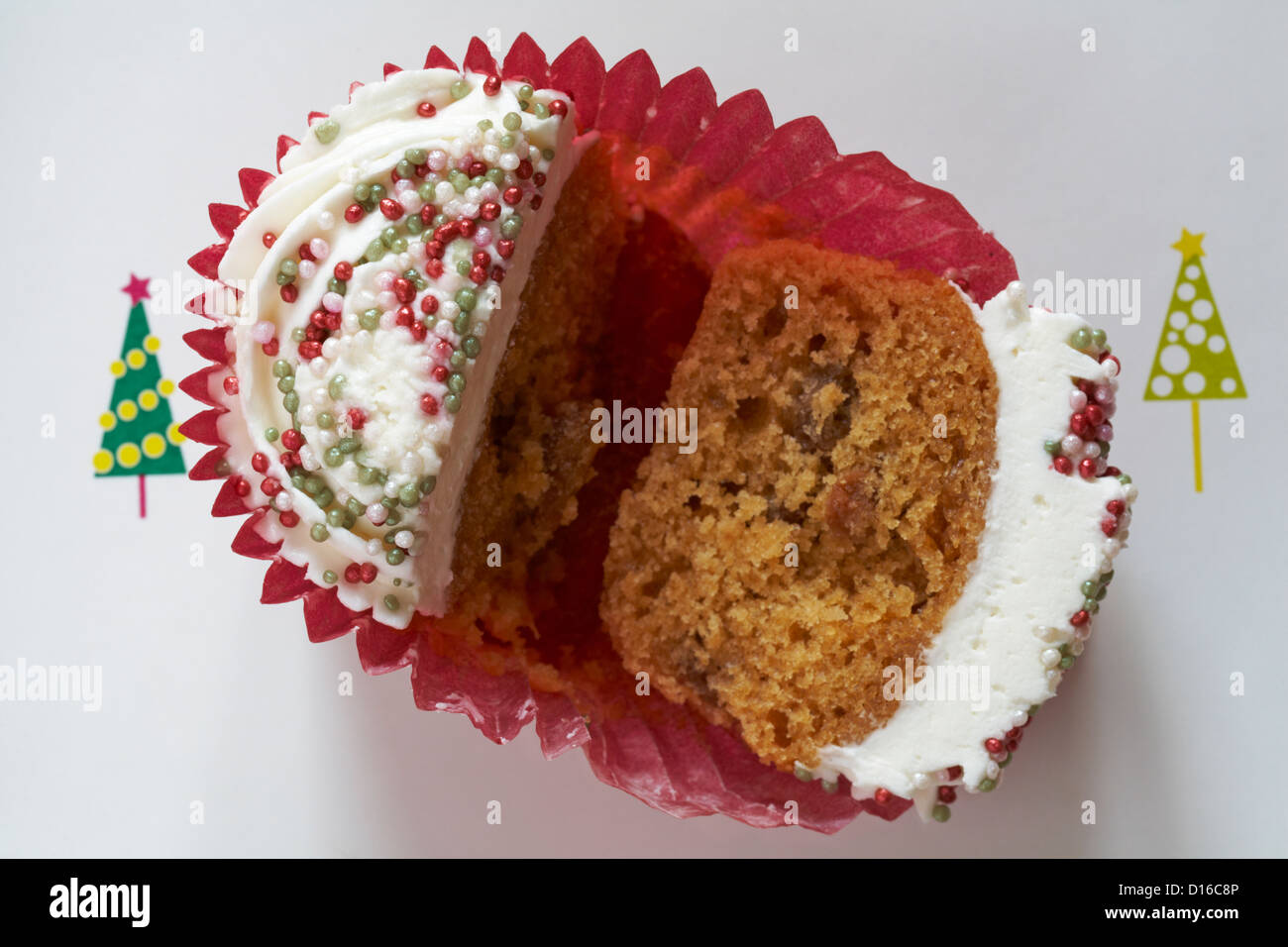 Christmas mince pie cupcake cut in half, halved, on festive plate with Christmas trees on Stock Photo