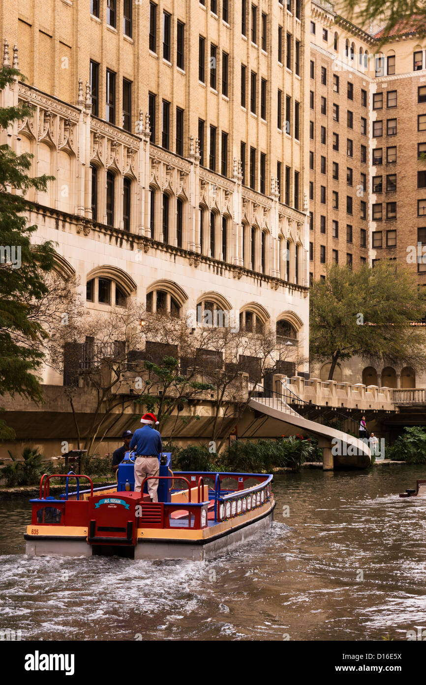 Empty river barge plies its way upstream through the San Antonio ...