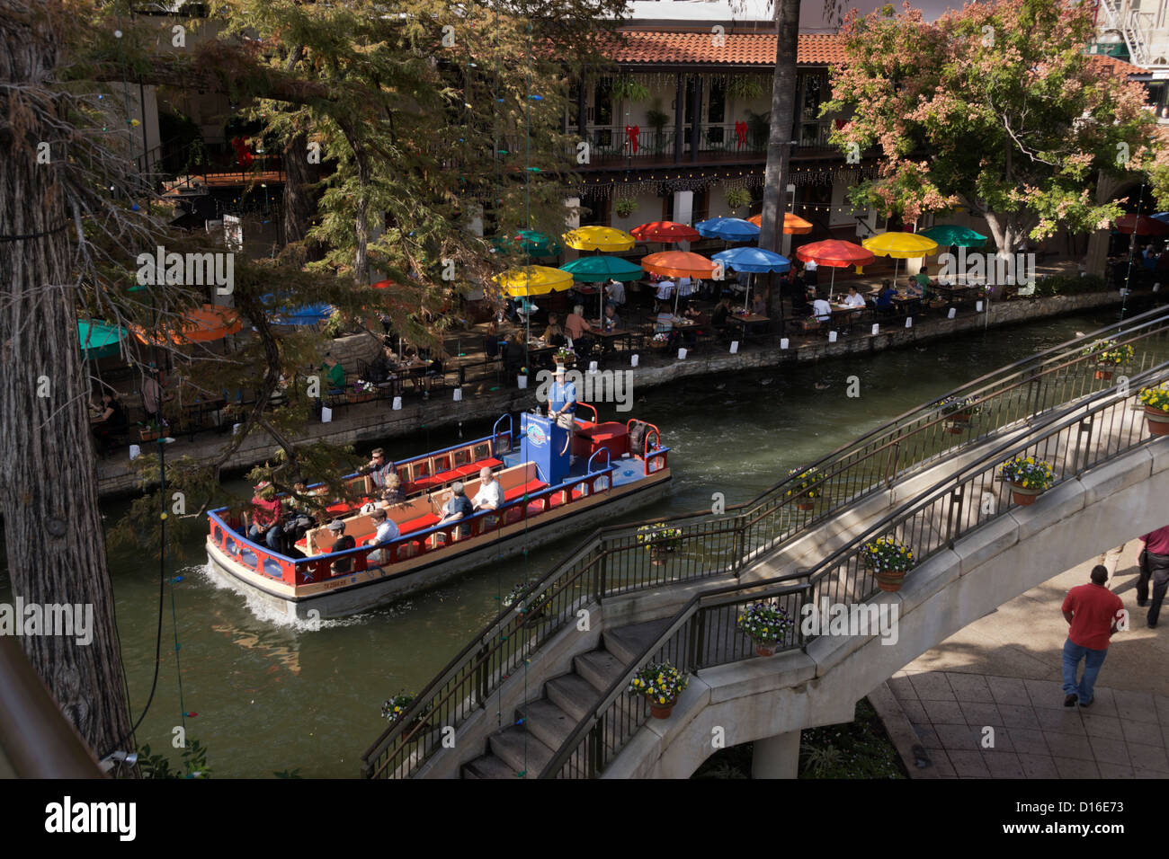 River barge transports tourists along the San Antonio River through the downtown Riverwalk in San Antonio, Texas. Stock Photo