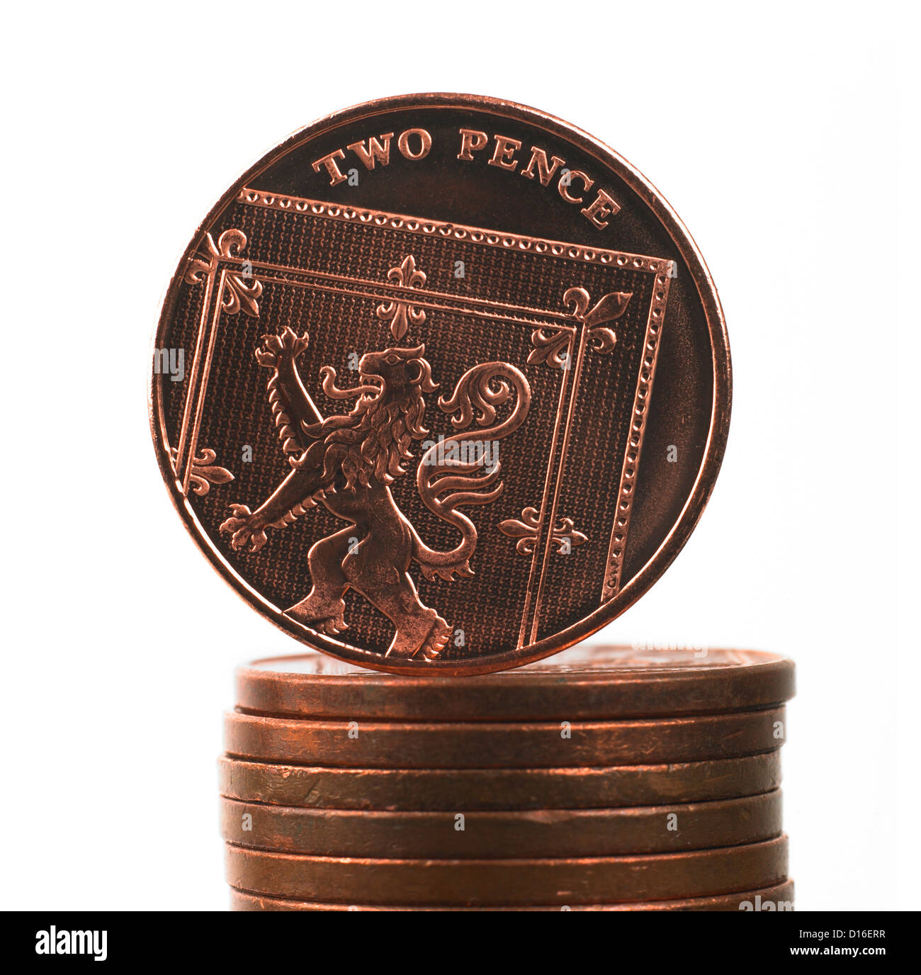 British two pence decimal coin balanced on top of pile of coins Stock