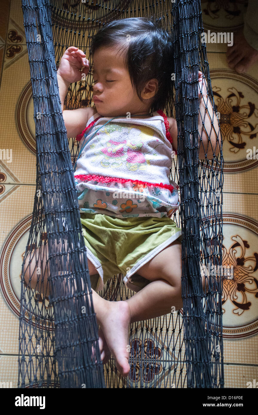 Picture of a Vietnamese baby sleeping in a black netted hammock Stock Photo  - Alamy