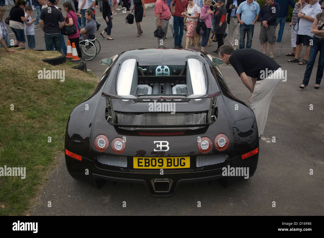 A crowd of people gathering around a Bugatti Veyron at a classic car show. Stock Photo