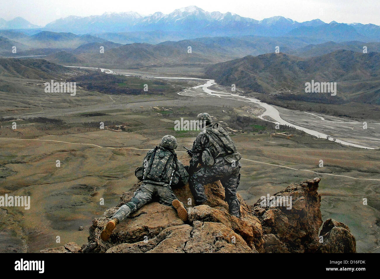 US Army Soldiers get view of the land on top of a ridge near Forward Operation Base Lane February 21, 2009 in Zabul Province, Afghanistan. Stock Photo