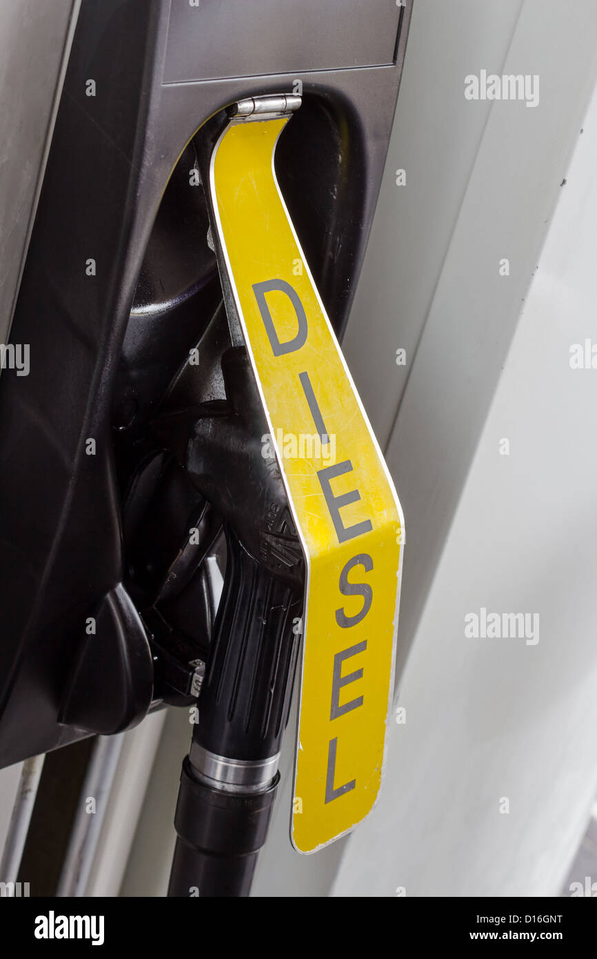 Fuel nozzle behind yellow flap indicating diesel Stock Photo