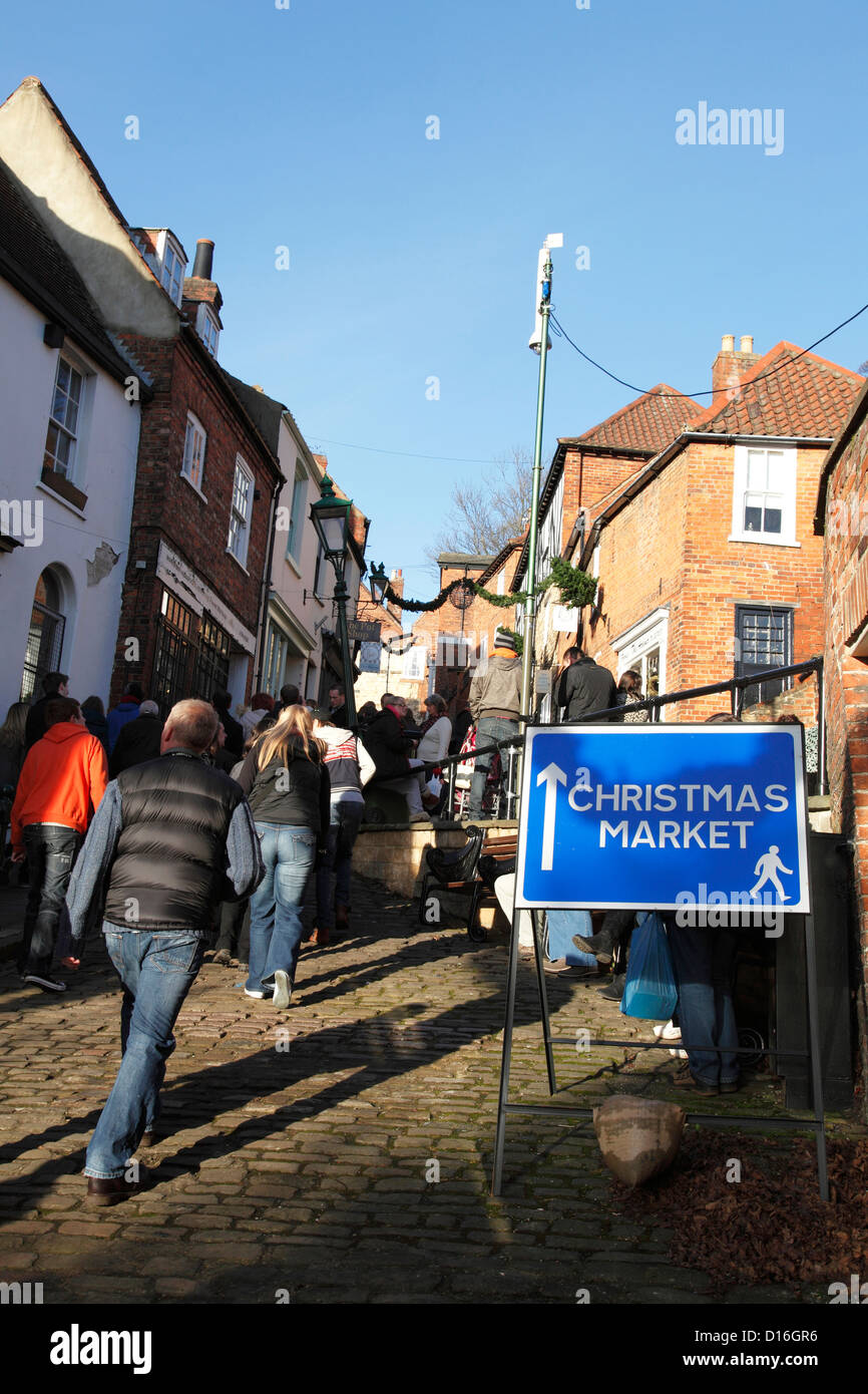 Visitors walking to the Lincoln Christmas Market, Steep Hill, Lincoln, England, U.K. Stock Photo