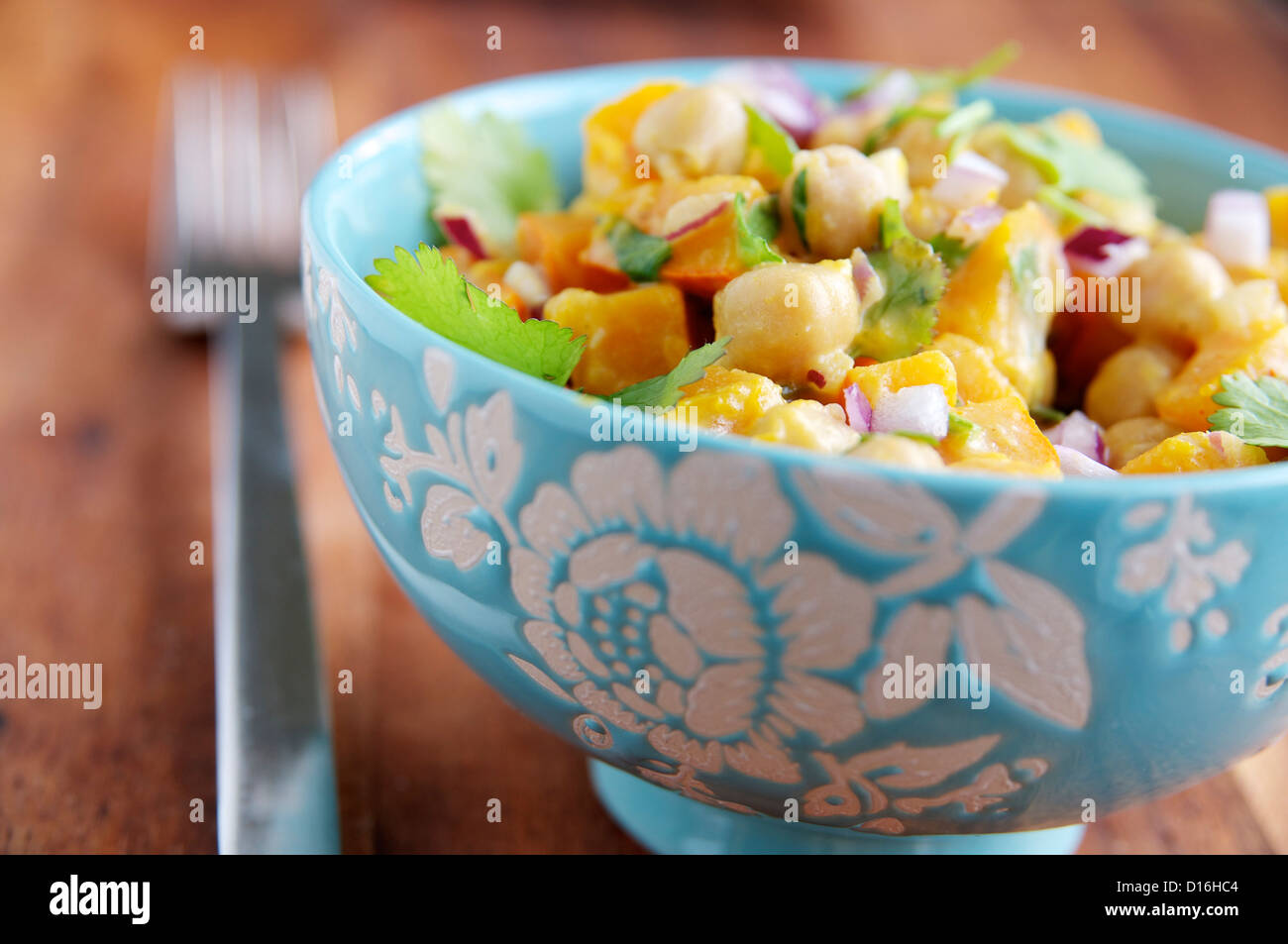 Warm pumpkin and chickpea Salad with a tahini dressing in a bowl. Stock Photo